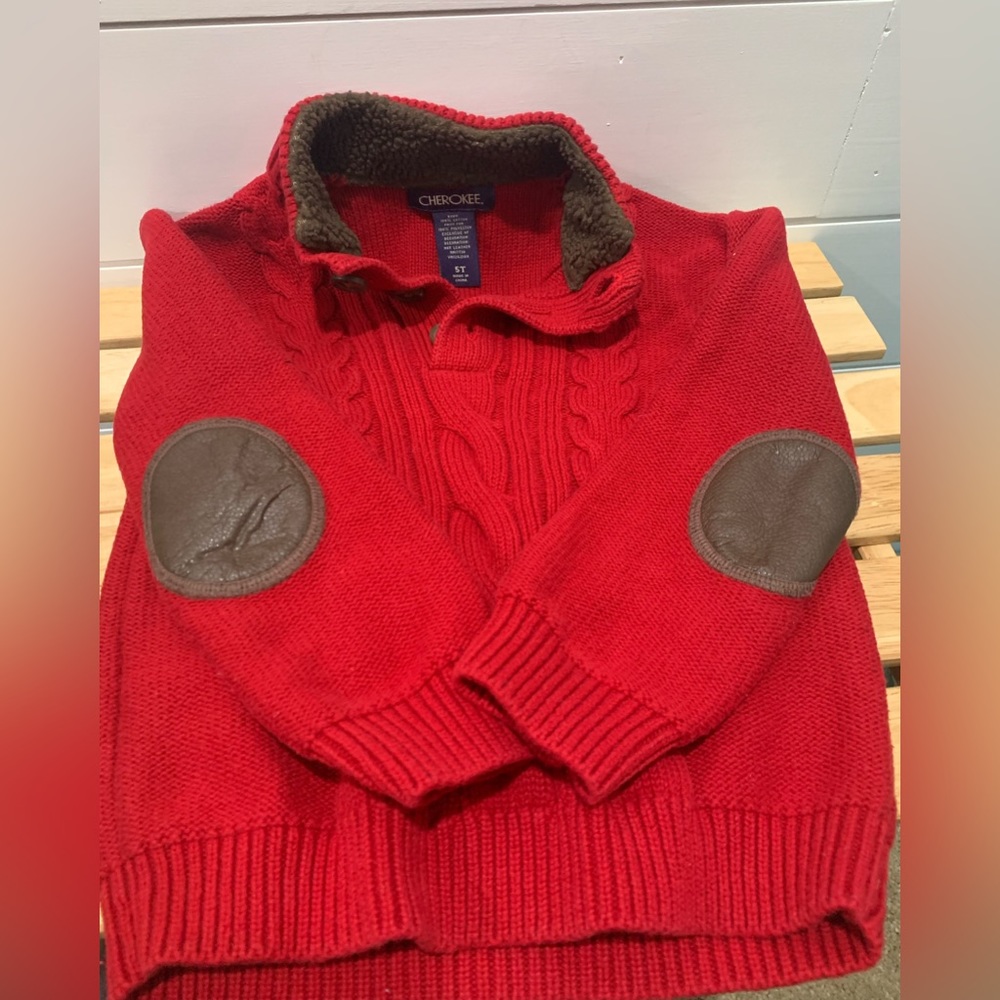 Red sweaters with brown elbow patch accents.